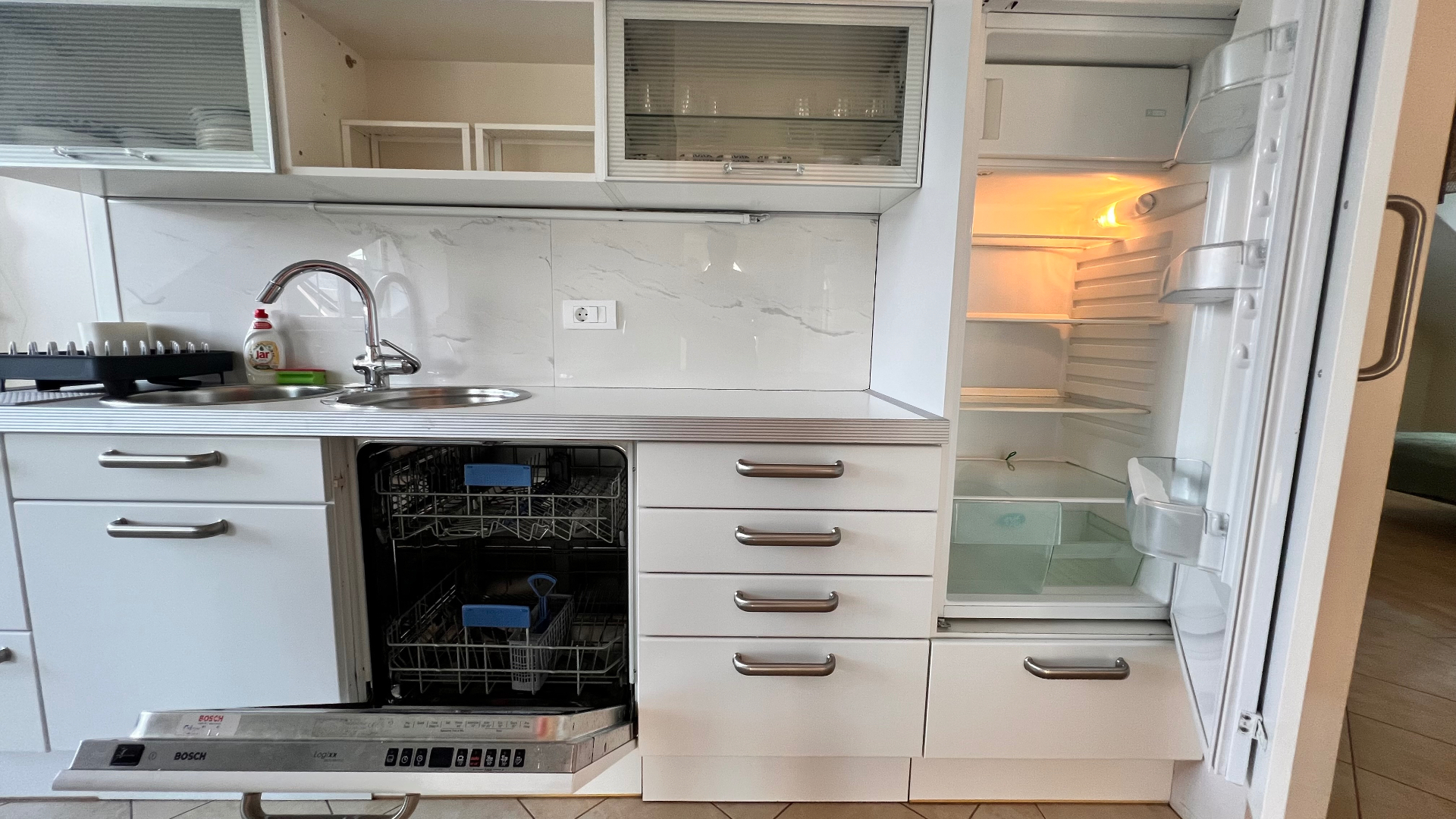 Fully equipped kitchen with dishwasher and fridge
